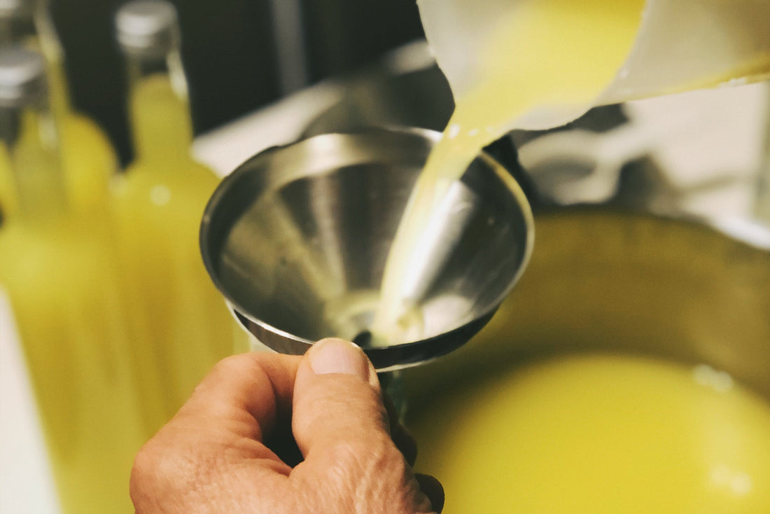 Liquid oil flowing smoothly into a bowl